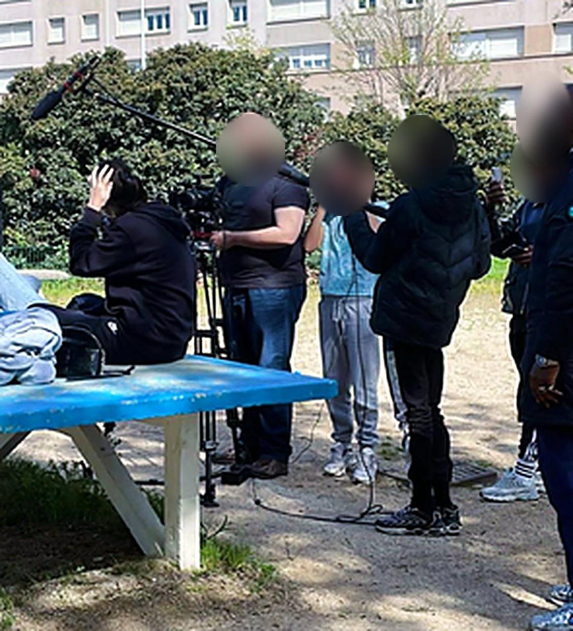 Tournage d'une saynète du projet Passage à l'acte : des jeunes au micro et à la perche, avec un caméraman, dans un parc.